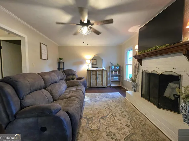 a living room with furniture a flat screen tv and a fireplace
