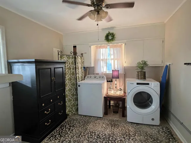 a view of a dining room with furniture large windows and wooden floor