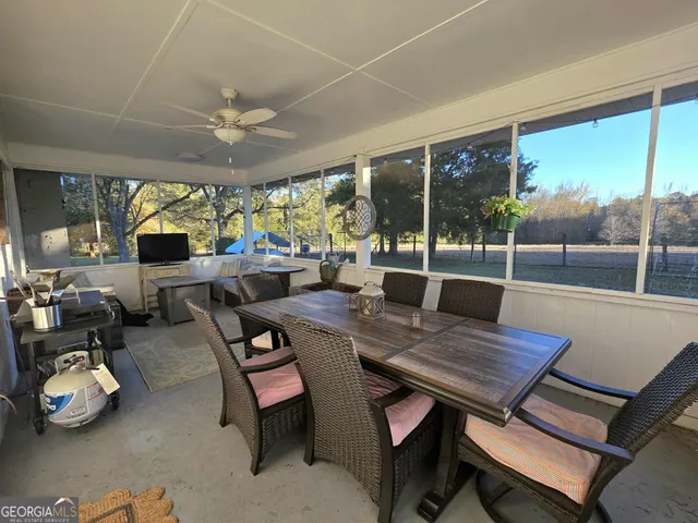 a view of a dining room with furniture a chandelier and wooden floor