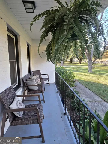 a view of a balcony with chairs