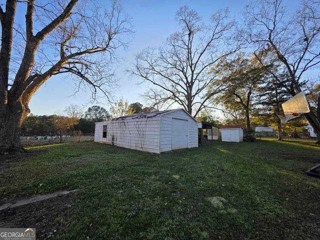 a view of a backyard with large trees