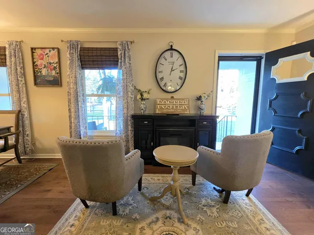 a living room with furniture a window and a clock