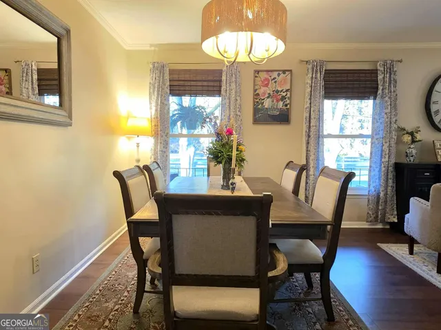 a view of a dining room with furniture wooden floor and chandelier