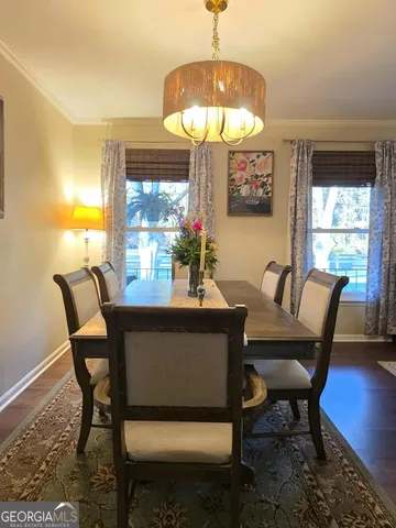 a dining room with furniture lamps and a chandelier