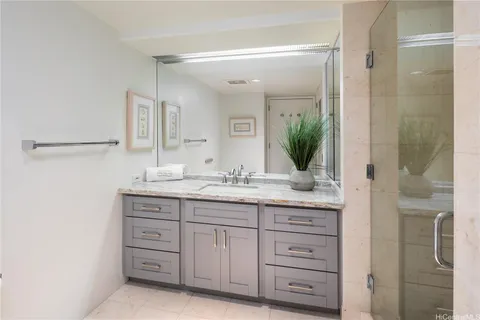 a bathroom with a granite countertop sink a mirror and a