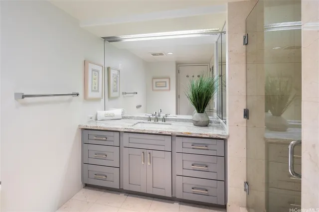 a bathroom with a granite countertop sink a mirror and a