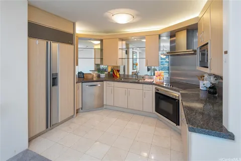 a kitchen with granite countertop a sink stainless steel appliances and cabinets