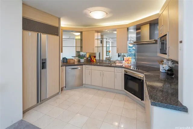 a kitchen with granite countertop a sink stainless steel appliances and cabinets