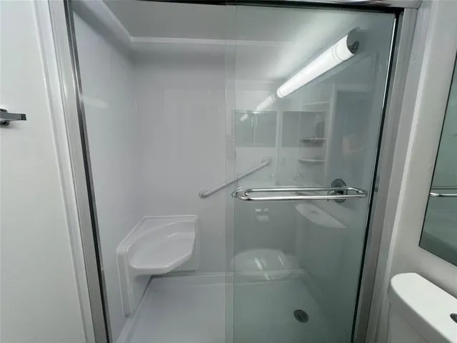 a bathroom with a shower and toilet