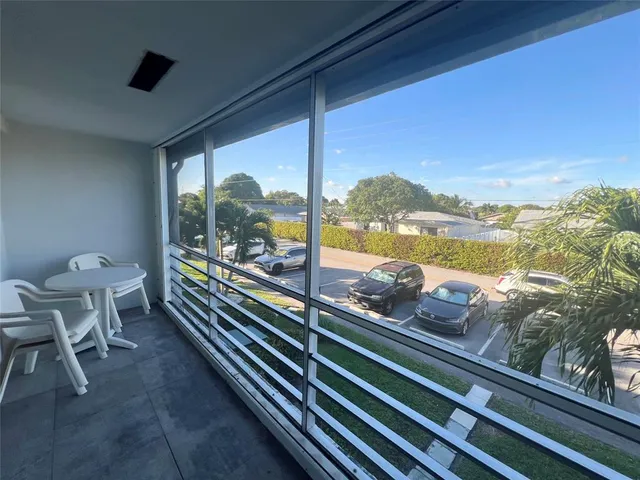 a view of a chairs and table in a balcony