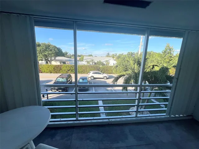 a view of a room with wooden floor and windows