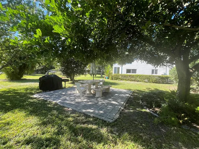 a view of backyard with patio and garden