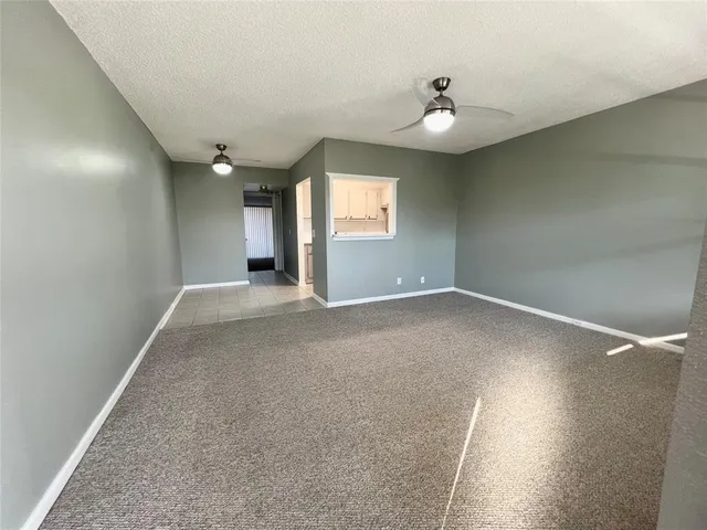 an empty room with windows and entrance