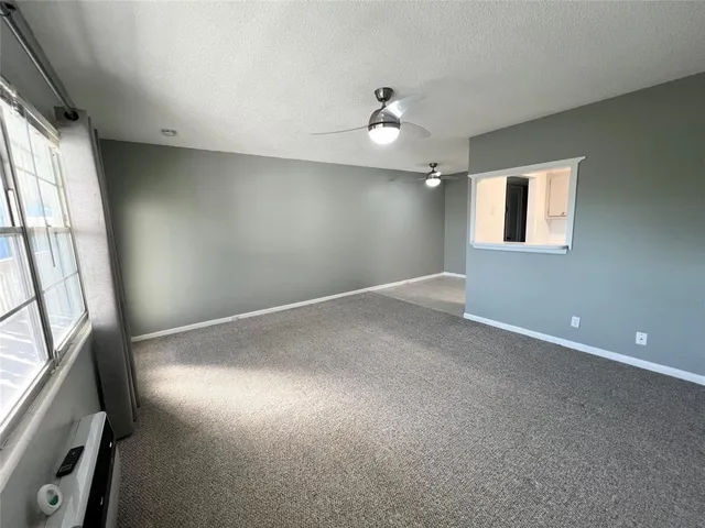 an empty room with windows and entrance