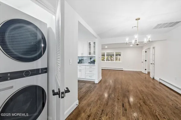 a view of a kitchen with a sink and dishwasher a refrigerator with wooden floor