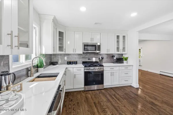 a kitchen with stainless steel appliances a refrigerator sink and cabinets