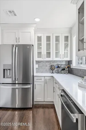 a kitchen with white cabinets and white appliances