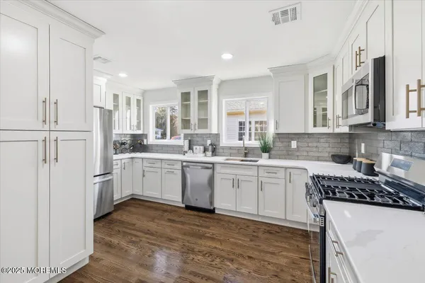 a view of a room with wooden floor and white walls