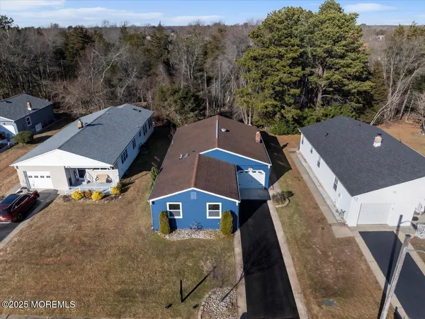 an aerial view of a house with a yard