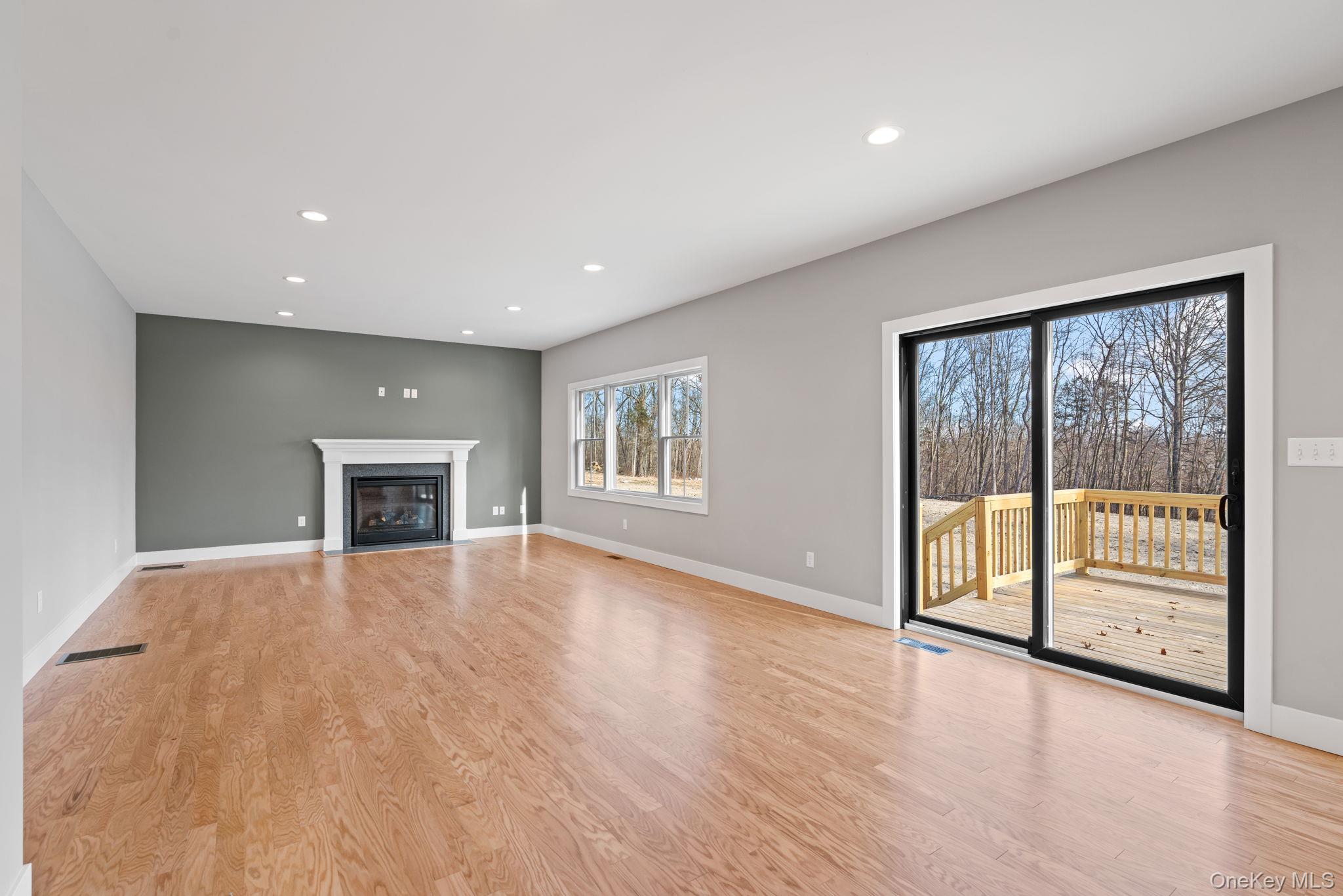 13 Harrier Ridge Drive Wallkill, NY 12589 - Photo 7 of 40 Unfurnished living room with recessed lighting, light wood-style floors, and a fireplace with flush hearth