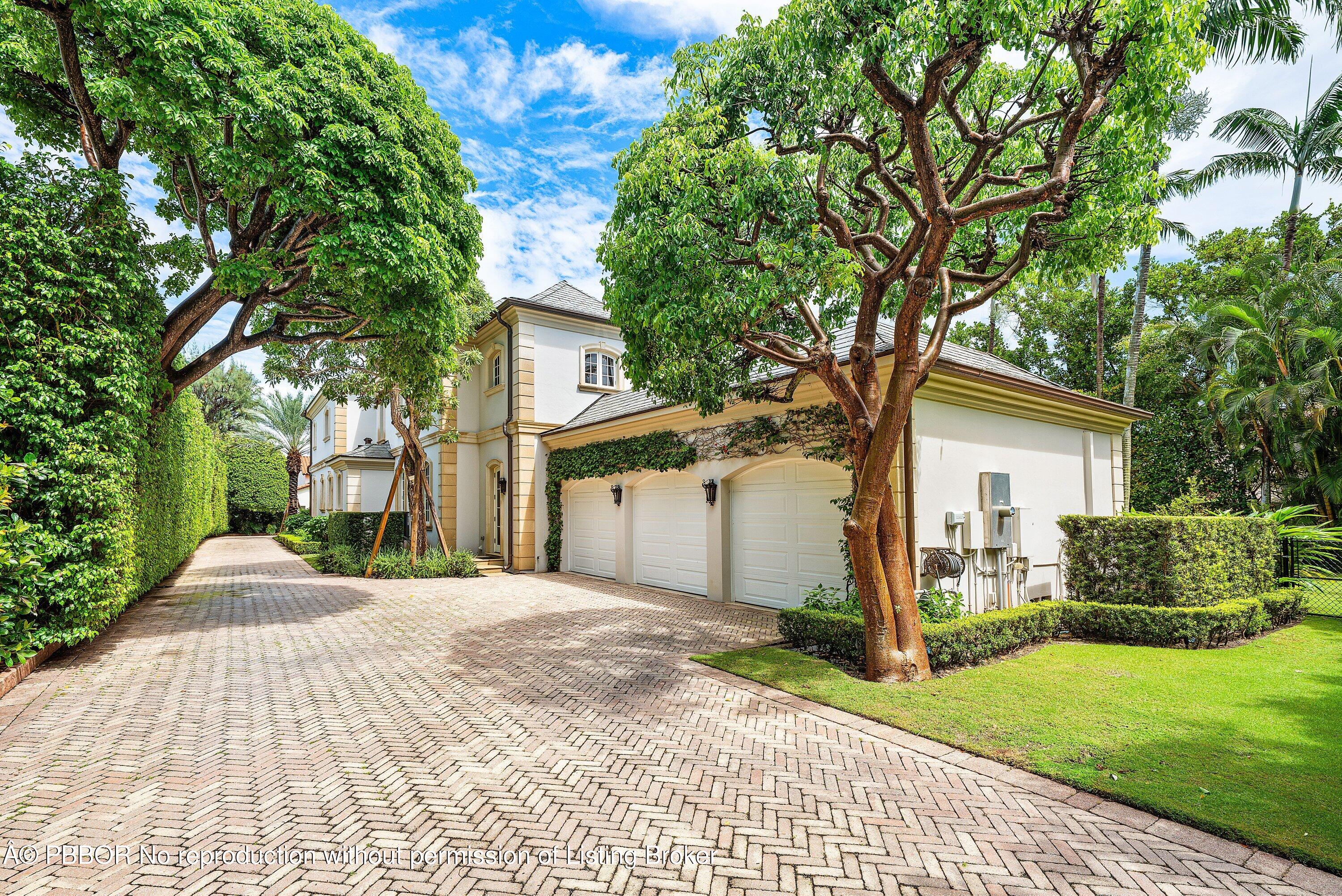242 Wells Road Palm Beach, FL 33480 - Photo 34 of 54 a front view of a house with a yard and trees