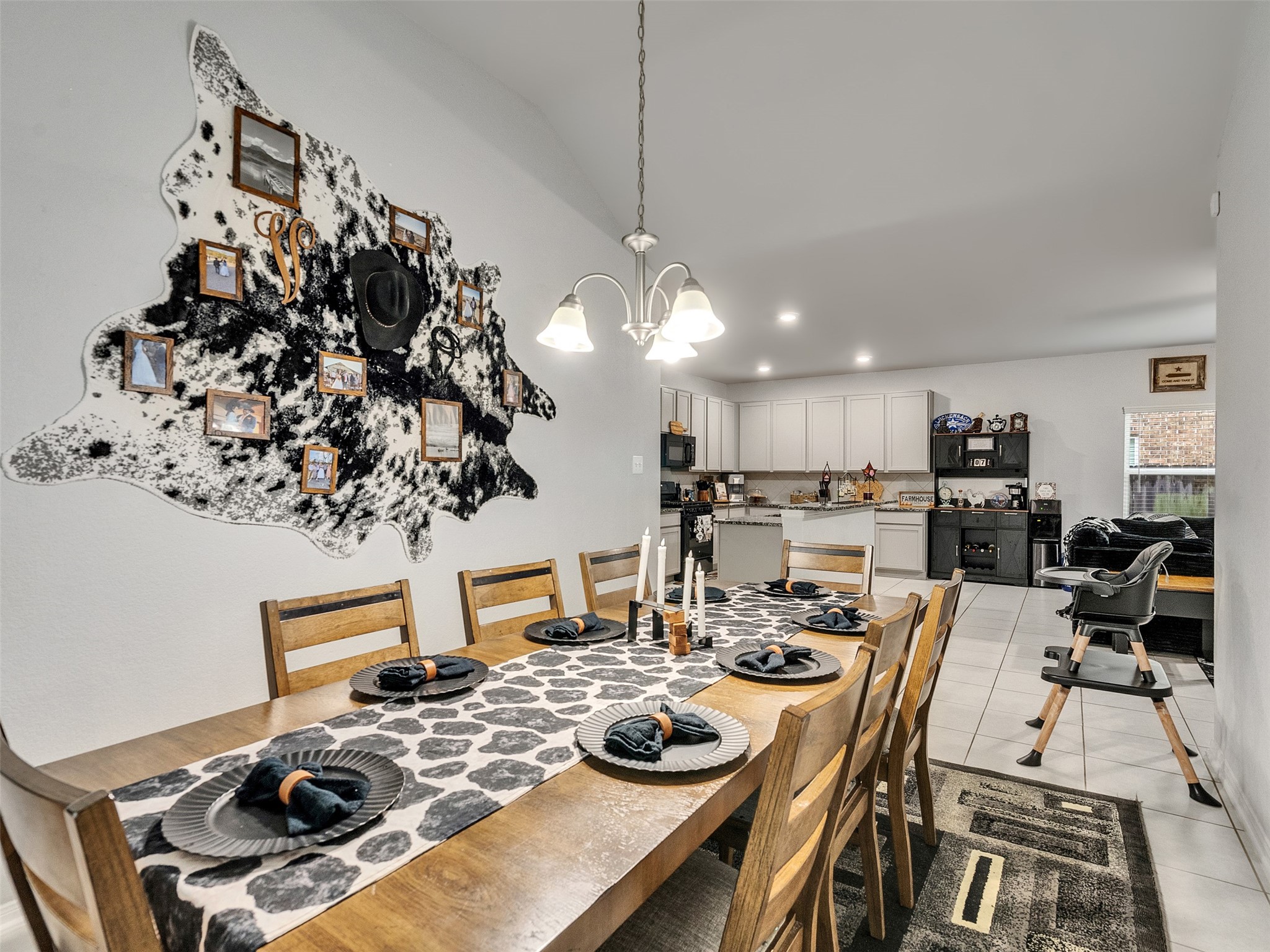 8719 Willet Street Baytown, TX 77521 - Photo 21 of 42 a view of a dining room with furniture and a chandelier