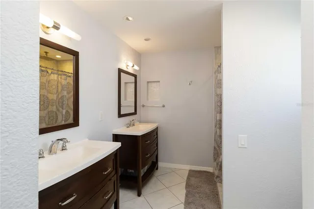 a bathroom with 2 sink and a mirror