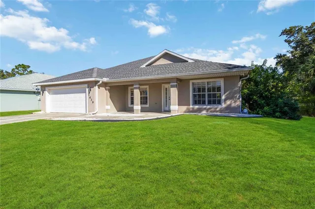 a front view of house with yard and green space