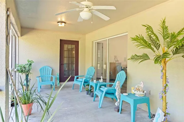 a dining room with furniture and a floor to ceiling window