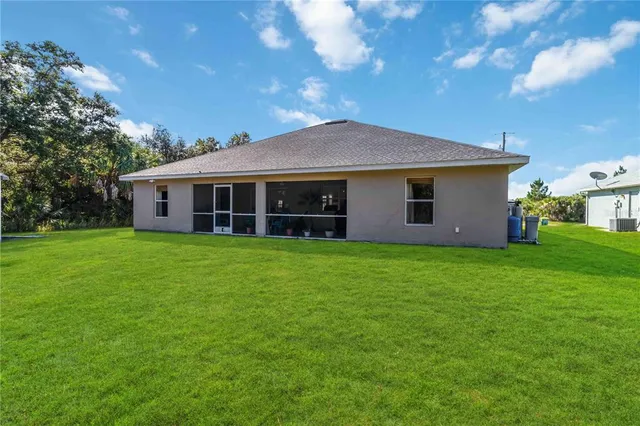 a view of a house with a backyard