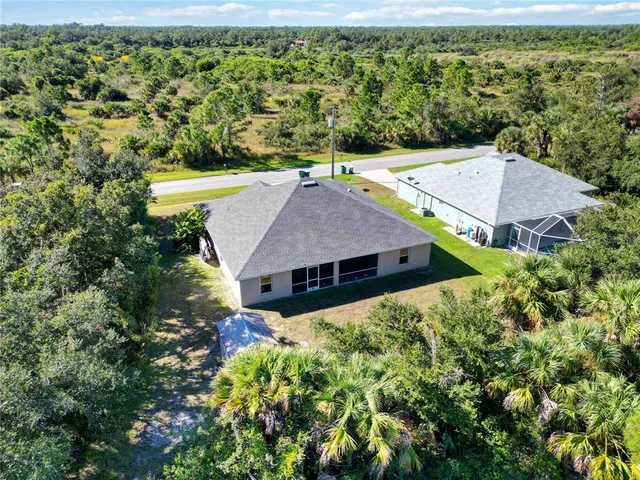 an aerial view of a house with yard and outdoor seating