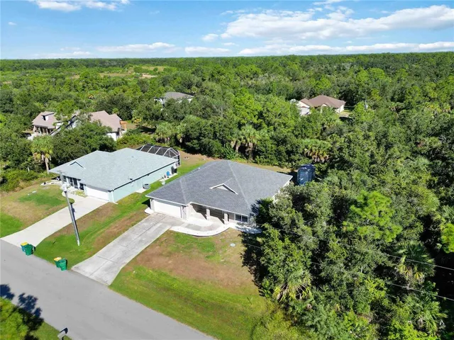 an aerial view of residential houses with outdoor space and street view