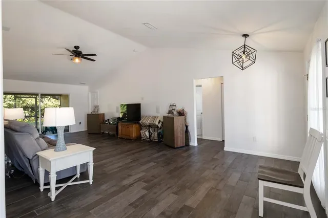 a view of a livingroom with furniture and a ceiling fan