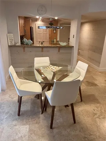 a dining room with furniture and a chandelier