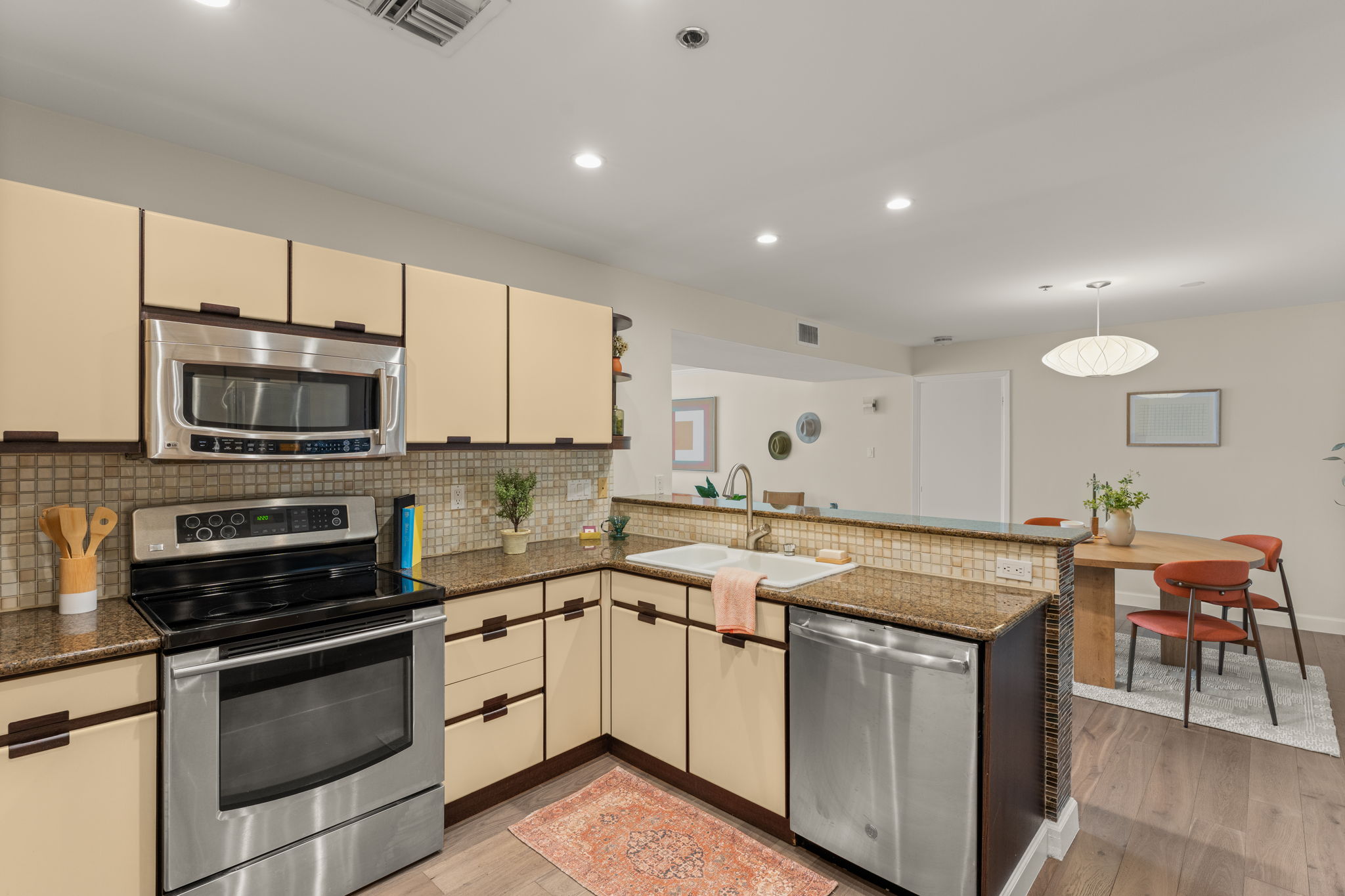 40 North Interstate Highway 35, Unit 11B2 Austin, TX 78701 - Photo 8 of 28 A well-lit kitchen featuring stainless steel appliances and an inviting granite countertop breakfast bar.