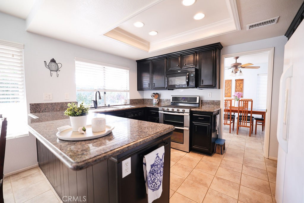 9057 Mandarin Lane Riverside, CA 92508 - Photo 12 of 38 Kitchen with recess lighting and newer gas range/convection oven