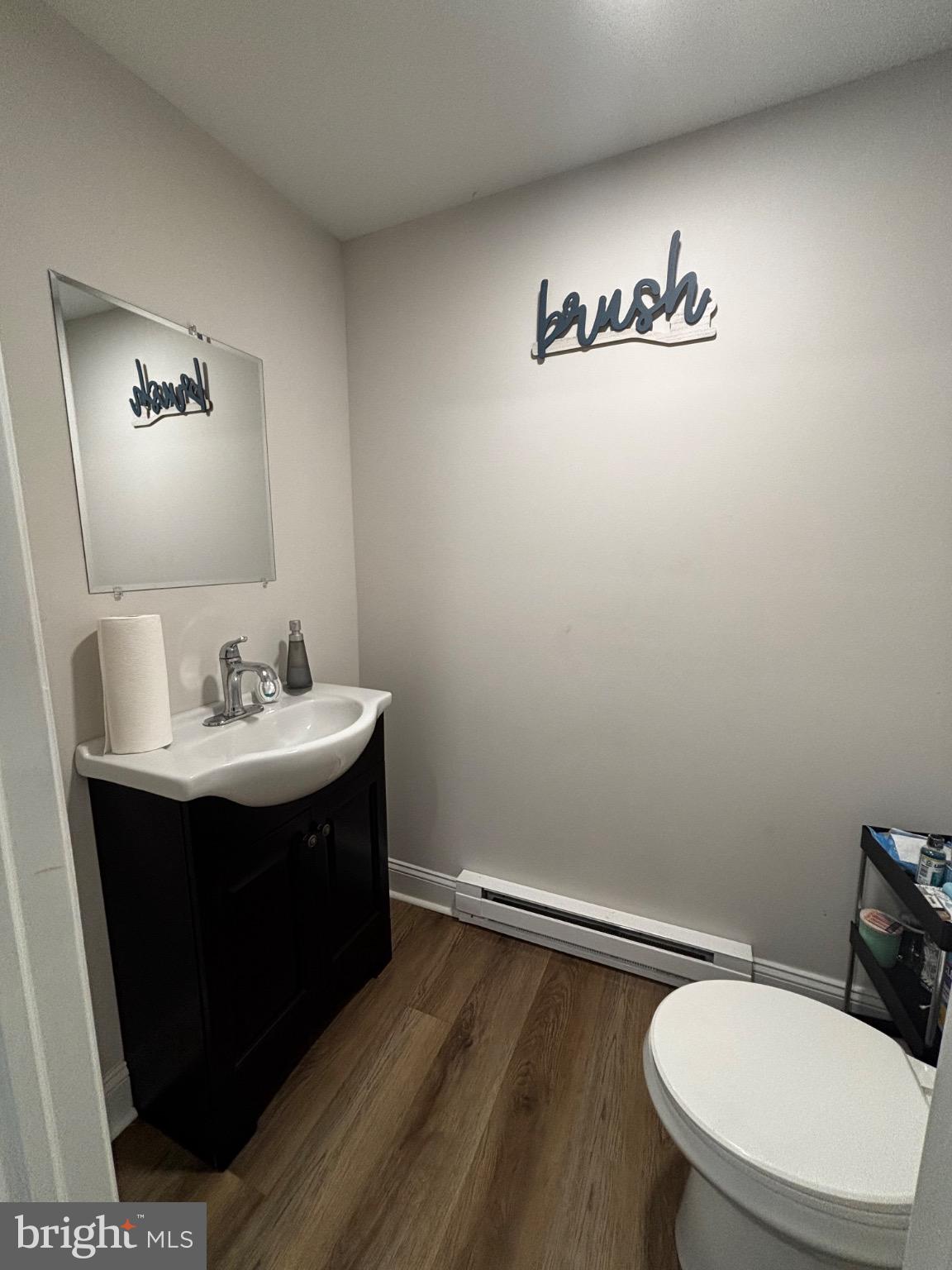 4 3rd Street Brookhaven, PA 19015 - Photo 12 of 21 a bathroom with a sink mirror vanity and toilet