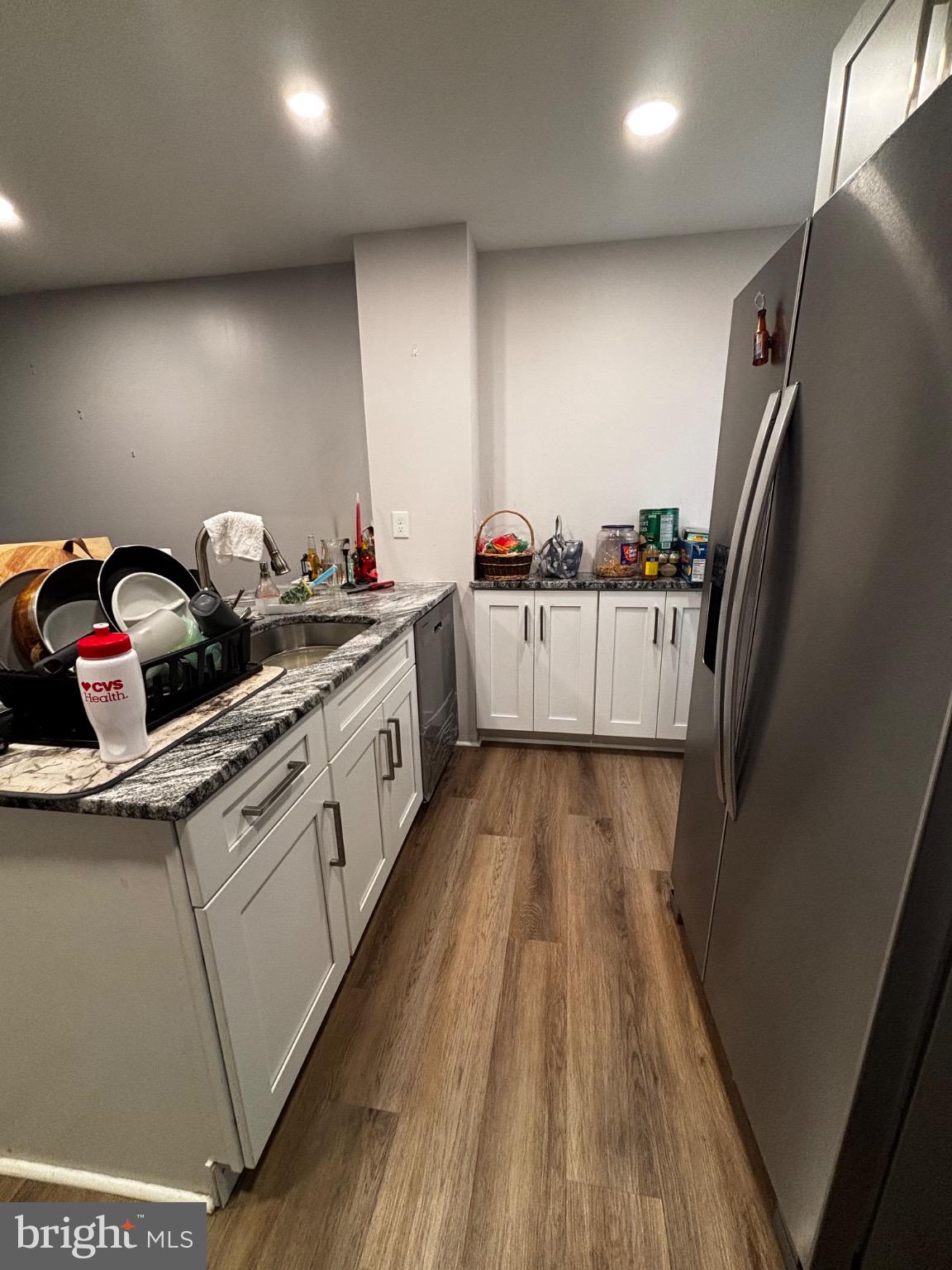 4 3rd Street Brookhaven, PA 19015 - Photo 7 of 21 a kitchen with a sink a refrigerator and wooden floor