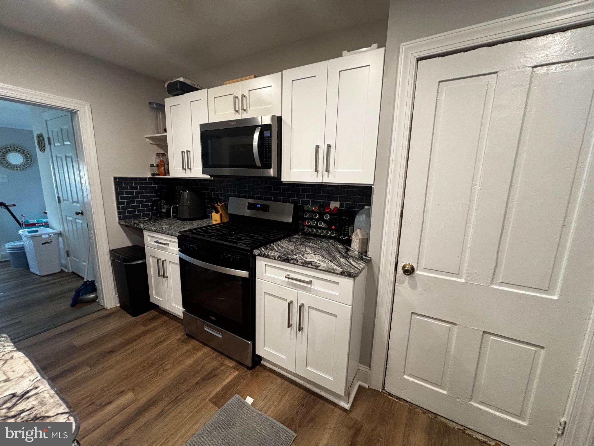 4 3rd Street Brookhaven, PA 19015 - Photo 9 of 21 a kitchen with a stove microwave and a sink