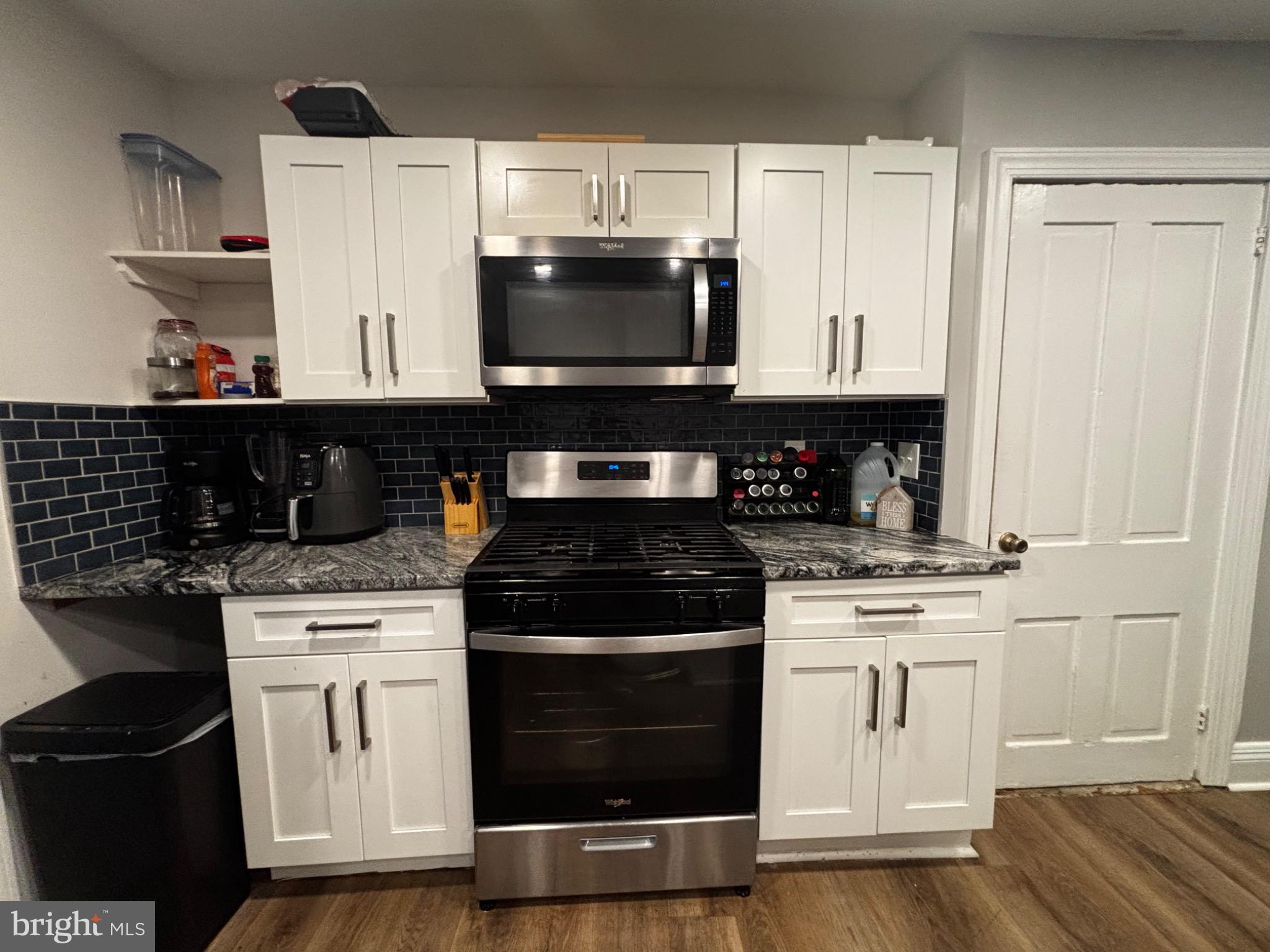 4 3rd Street Brookhaven, PA 19015 - Photo 10 of 21 a kitchen with stainless steel appliances granite countertop a stove and a microwave