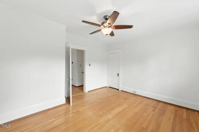 a view of a big room with wooden floor closet and windows