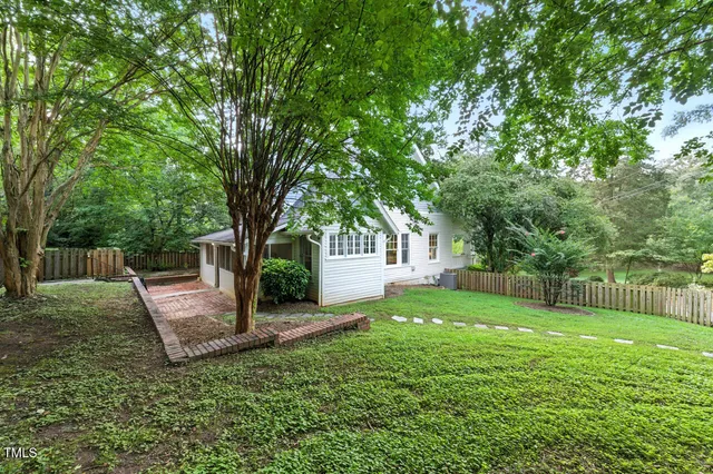 a view of a backyard with a tree