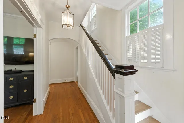 a view of entryway and hall with wooden floor