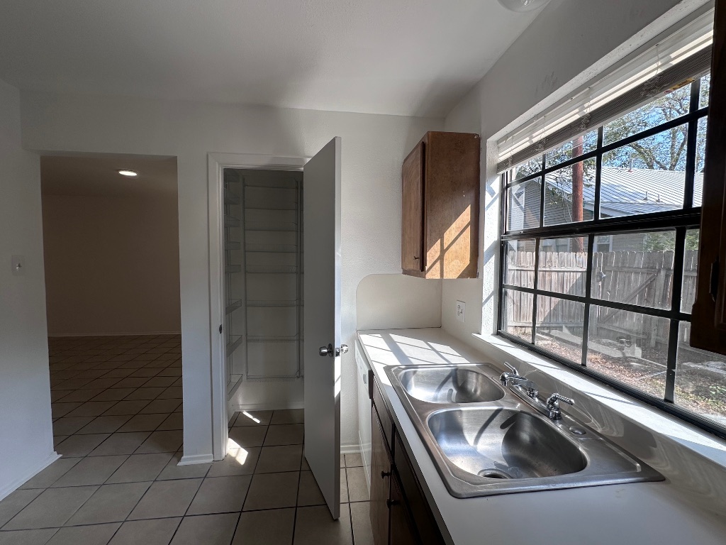1007 Water Street, Unit 104 Bastrop, TX 78602 - Photo 11 of 23 a bathroom with a sink and a tub