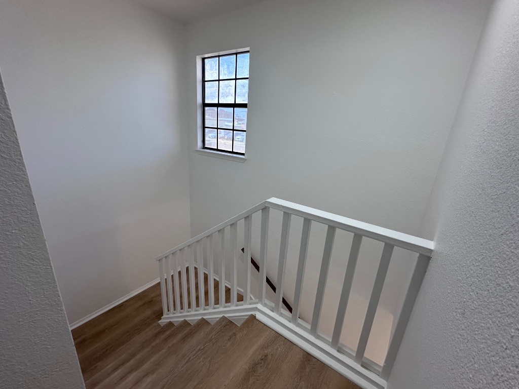 1007 Water Street, Unit 104 Bastrop, TX 78602 - Photo 13 of 23 a view of entryway with wooden floor