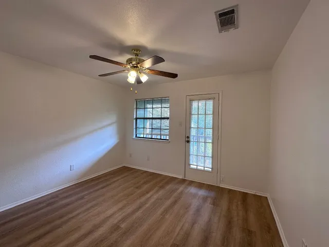 wooden floor in an empty room with a window