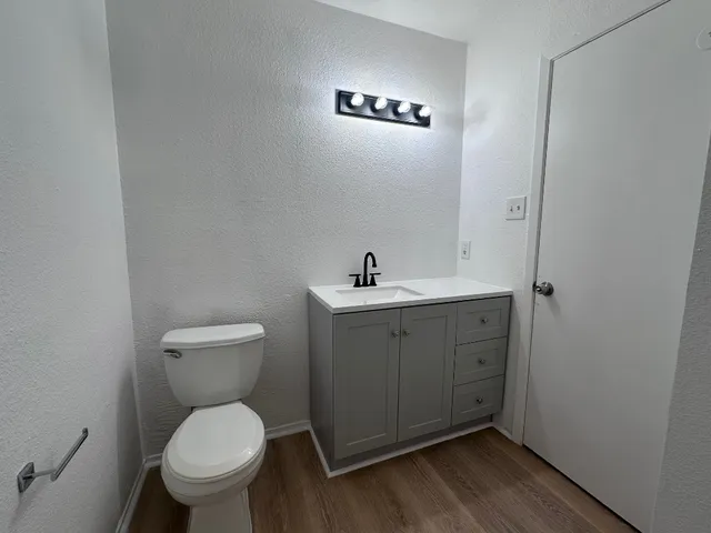 a bathroom with a toilet sink and mirror