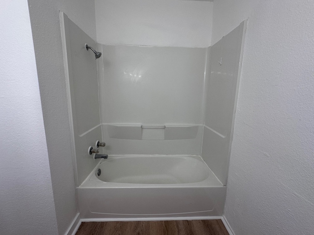 1007 Water Street, Unit 104 Bastrop, TX 78602 - Photo 17 of 23 a bathroom with a tub