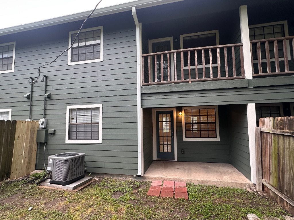 1007 Water Street, Unit 104 Bastrop, TX 78602 - Photo 22 of 23 a front view of a house with a yard