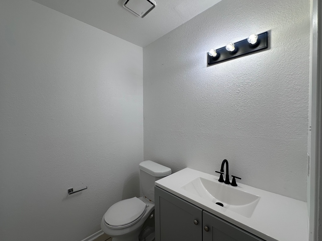 1007 Water Street, Unit 104 Bastrop, TX 78602 - Photo 7 of 23 a bathroom with a sink and a toilet